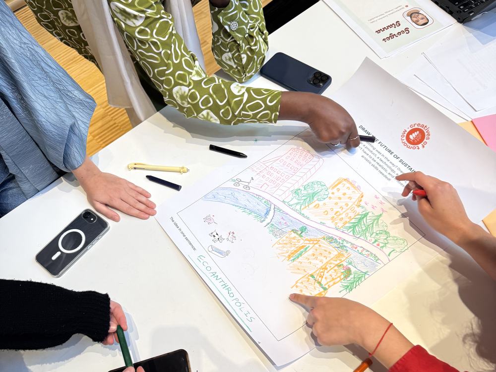 Workshop participants pointing at a hand-drawn map of their neighbourhood